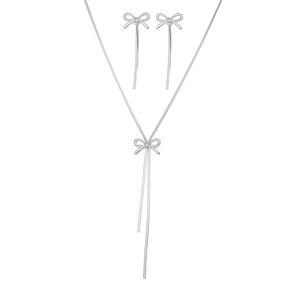 Silver necklace and earrings set on a white background