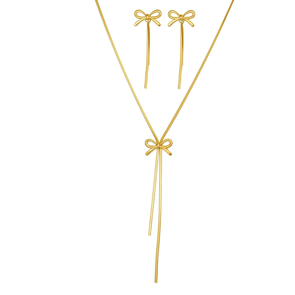 Gold necklace and earrings set on a white background